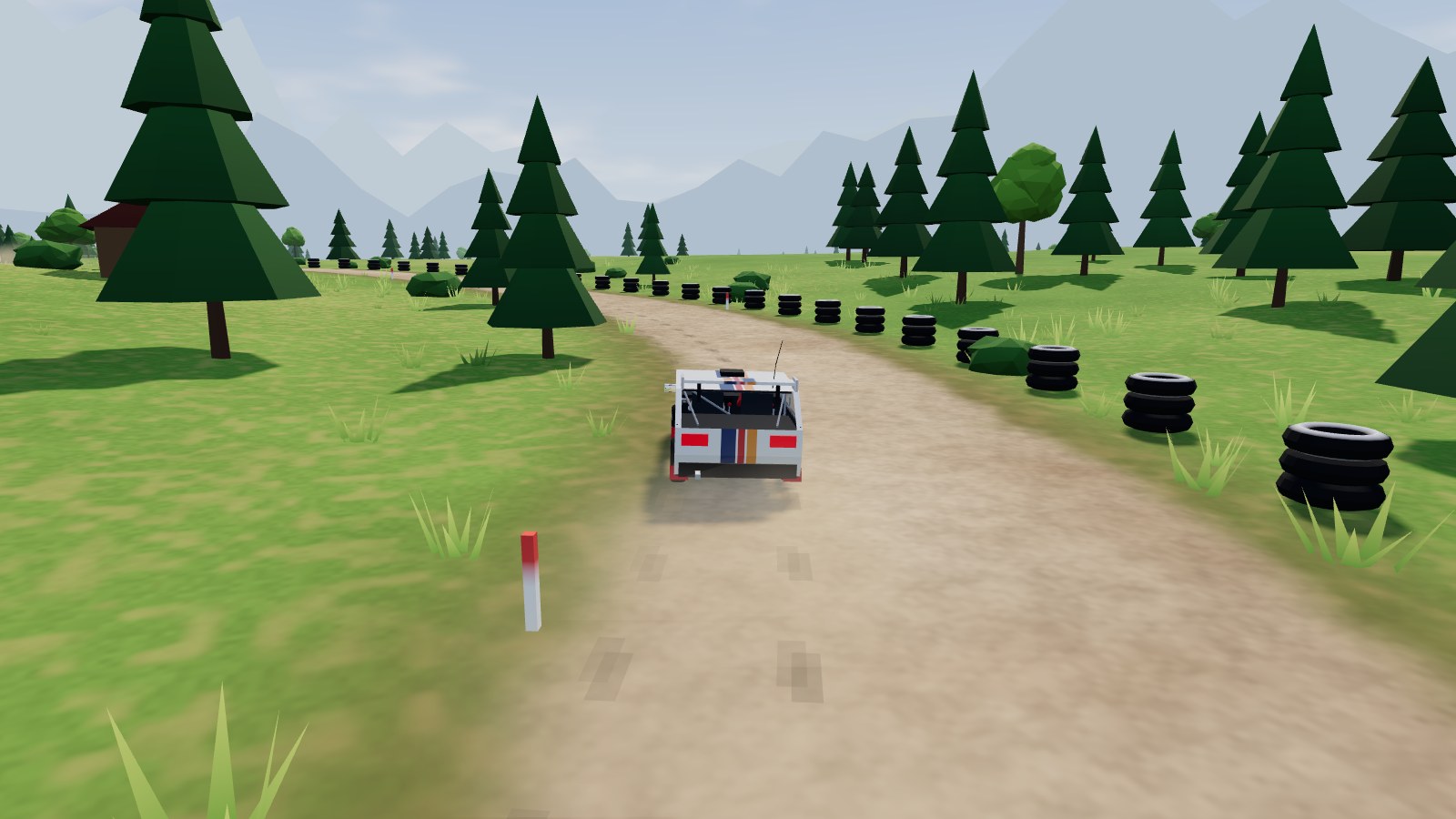 A rally car on a rallycross track lined with tyres.